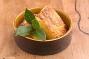 Bowl of Nigerian stockfish with green leaves garnish