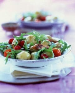 Fresh potato salad with cherry tomatoes and arugula greens