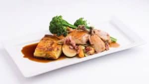 Roast chicken with gratin potatoes. vegetables and bacon