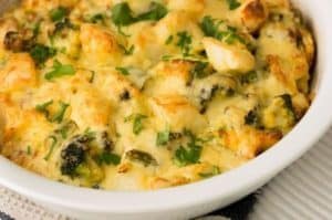 Baked cheesy spinach and chicken casserole in white dish