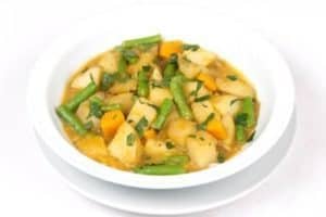 Vegetable soup with carrots, potatoes, and green beans bowl