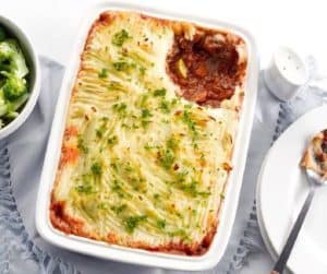 Baked shepherd's pie with mashed potato topping and herbs