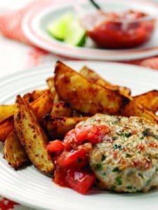 Grilled chicken burger with tomato salsa and potato wedges
