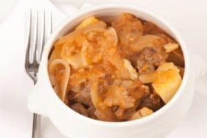 Hearty beef stew with onions and potatoes in bowl