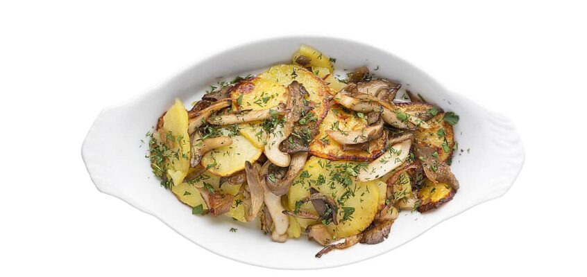 Appetizing dish of fried potatoes with mushrooms. Restaurant service concept.