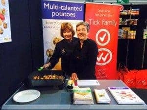Two women promoting multi-talented potatoes at event booth