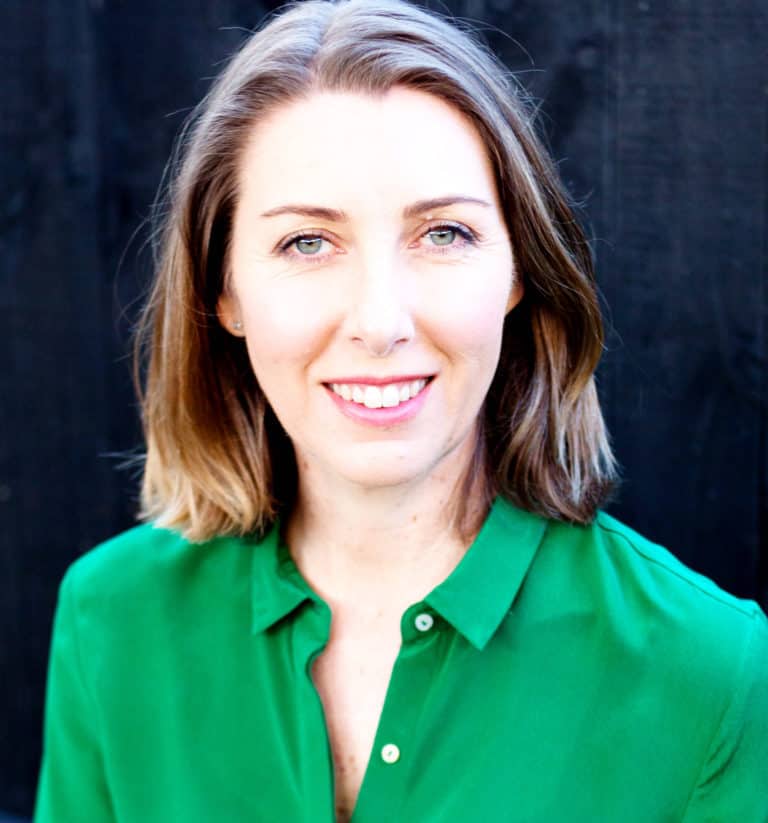 Smiling woman with short hair wearing green blouse