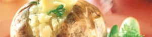 Baked potato with butter and fresh parsley garnish