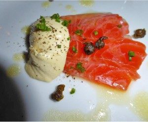 Smoked salmon with creamy sauce and capers garnish