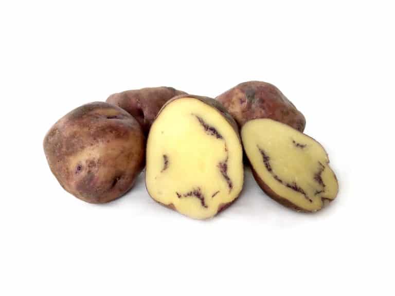 Purple streaked yellow-fleshed potatoes, whole and sliced.