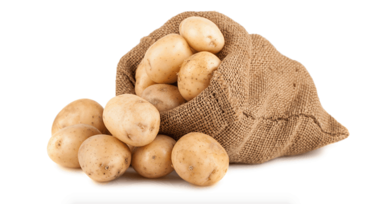 Burlap sack spilling fresh whole potatoes on white background