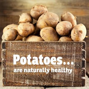 Box of raw potatoes with text "Potatoes are naturally healthy"