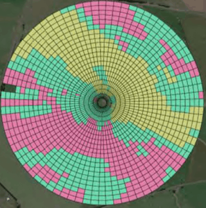 Aerial view of circular farmland with colored grid patterns