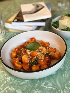 Bowl of gnocchi with tomato sauce and Parmesan cheese