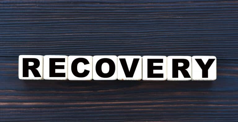 concept word RECOVERY on cubes on a beautiful dark wooden background
