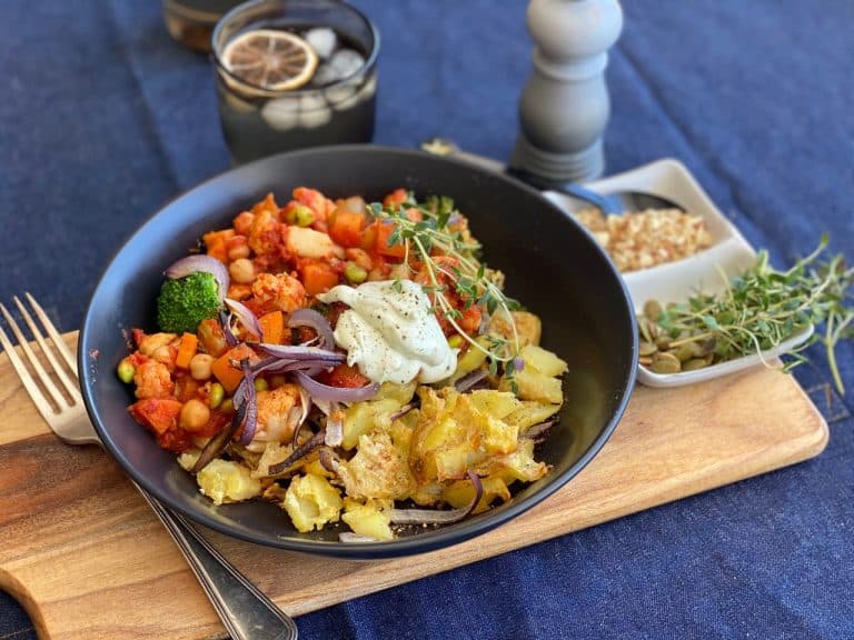 Bowl of roasted vegetables with chickpeas and creamy sauce