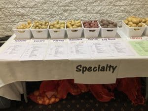Various specialty potato varieties in labeled white containers.