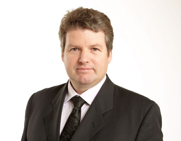 Professional middle-aged man in black suit and tie portrait