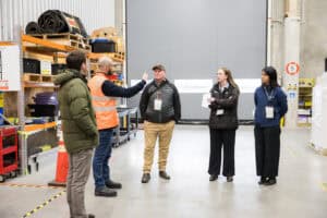 Group of warehouse workers having discussion during briefing meeting