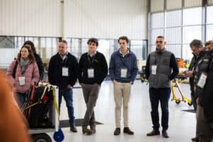 Group of people standing indoors at industrial or training facility