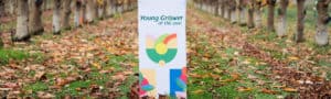 Young Grower of the Year sign in autumn orchard with fallen leaves