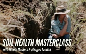 Woman examining soil in deep trench for soil health masterclass