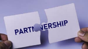 Partnership and Collaboration Concept with Two Jigsaw Puzzle Pieces Connecting Together